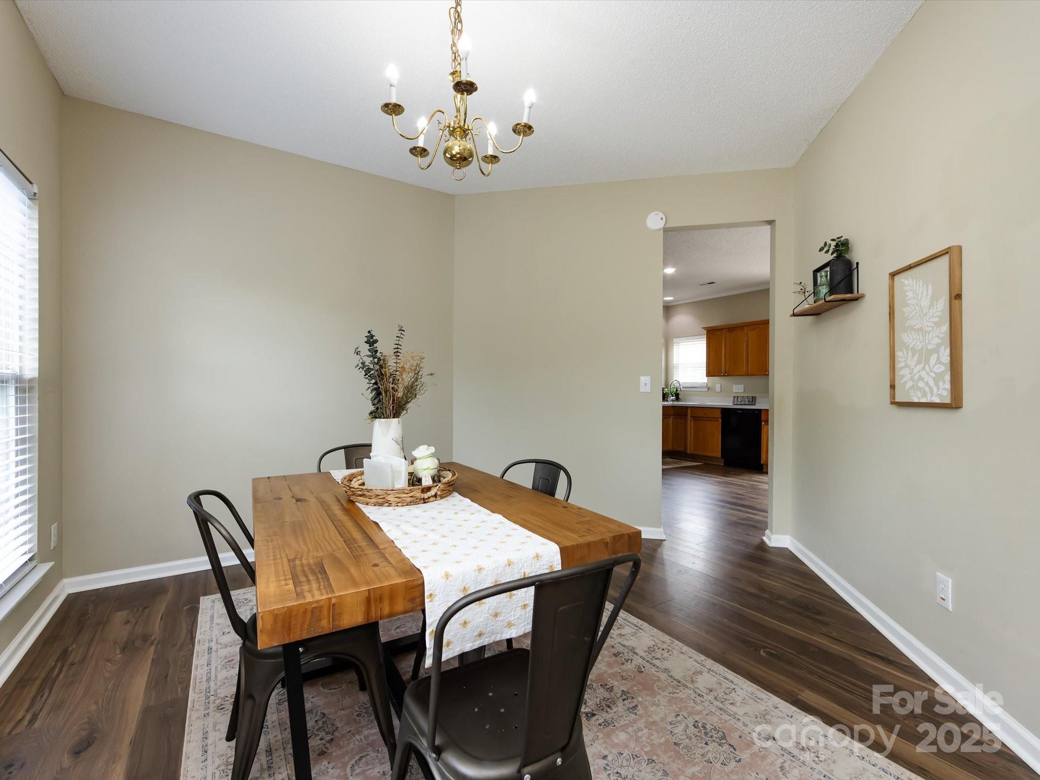 3910 Faith Church Road Indian Trail, NC 28079 - Photo 11 of 47 a view of a dining room with furniture and wooden floor