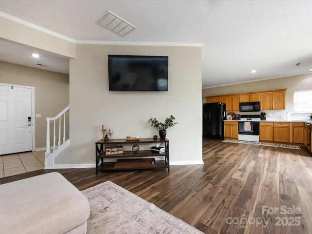 a kitchen with stainless steel appliances wooden floors and wooden cabinets