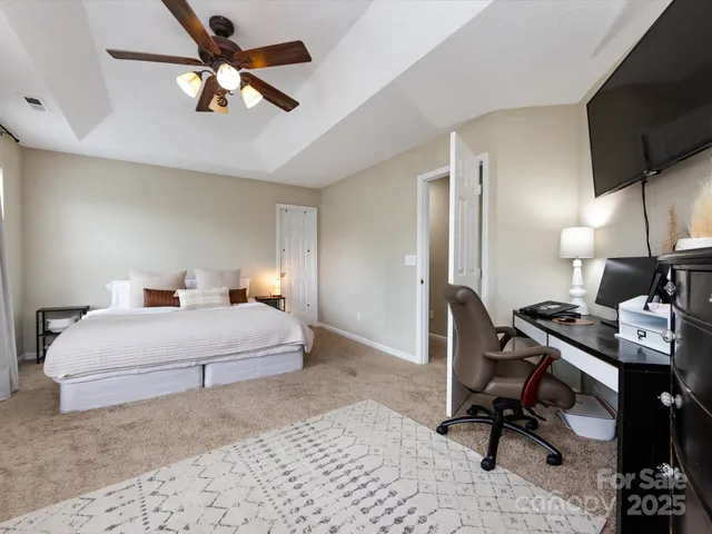 a bedroom with a bed and lamp