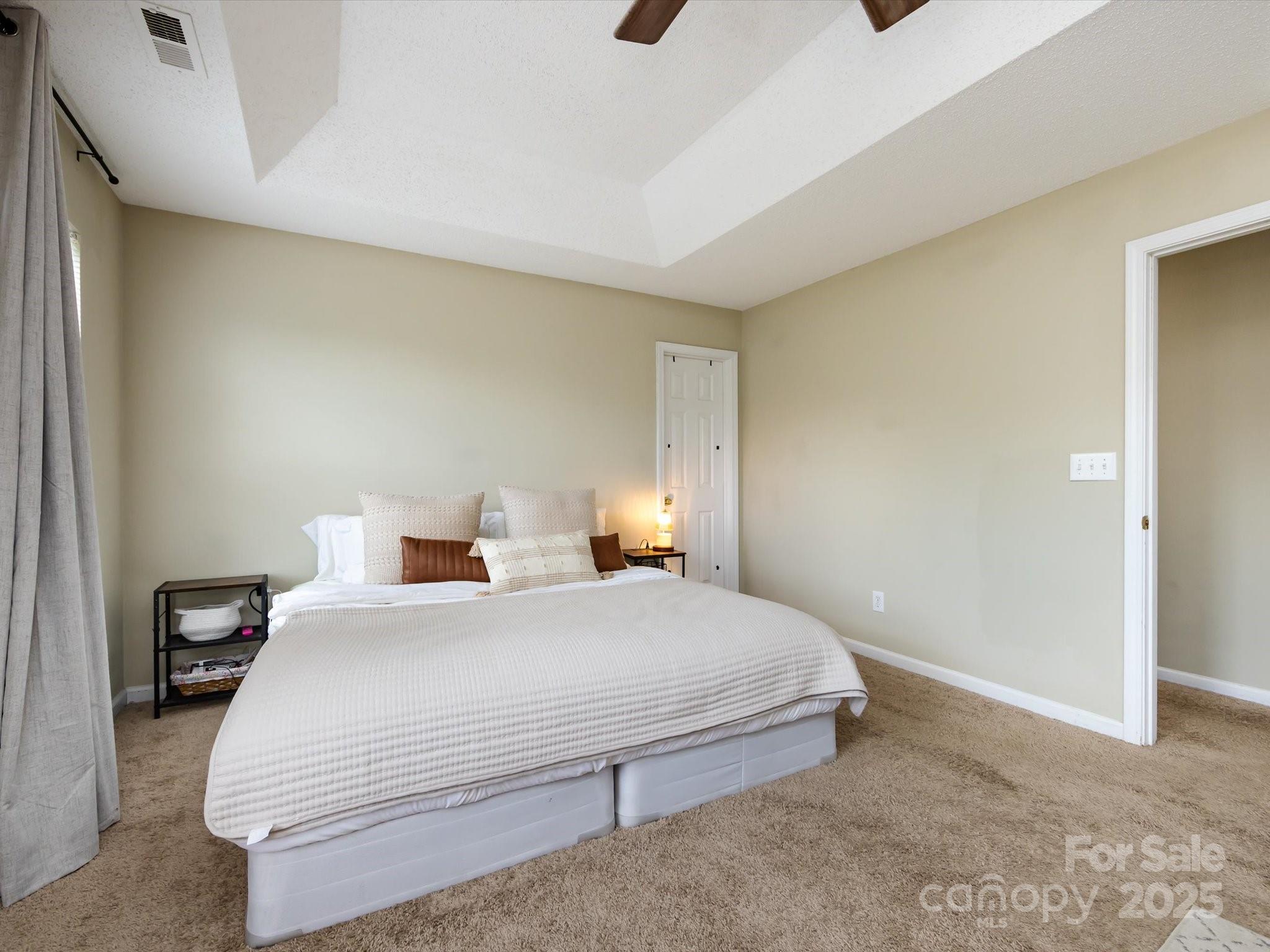 3910 Faith Church Road Indian Trail, NC 28079 - Photo 27 of 47 a bedroom with a bed and lamp