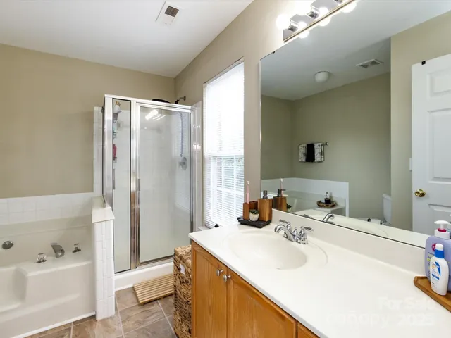 a bathroom with a bathtub and a shower