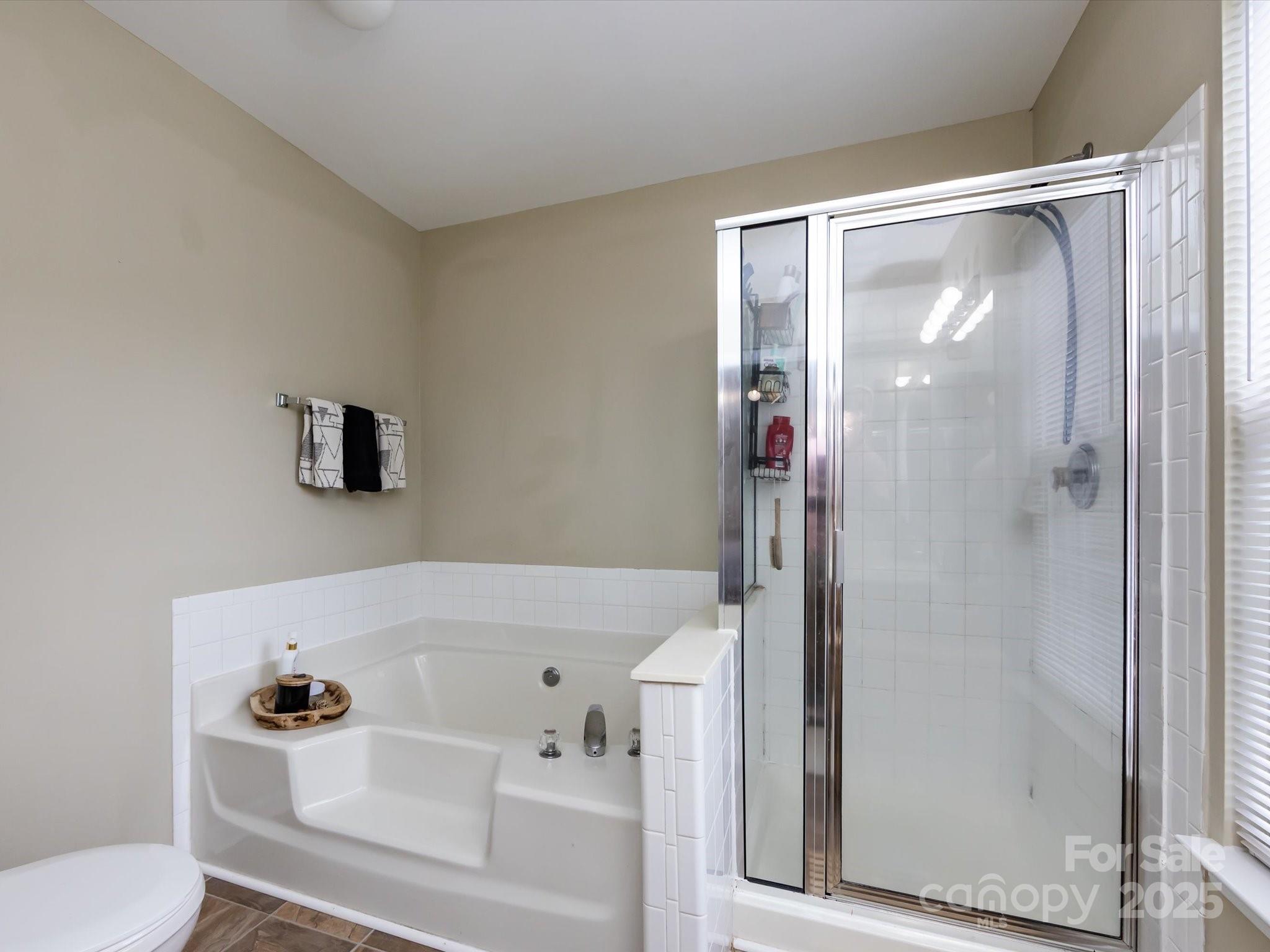 3910 Faith Church Road Indian Trail, NC 28079 - Photo 29 of 47 a bathroom with a bathtub and a shower