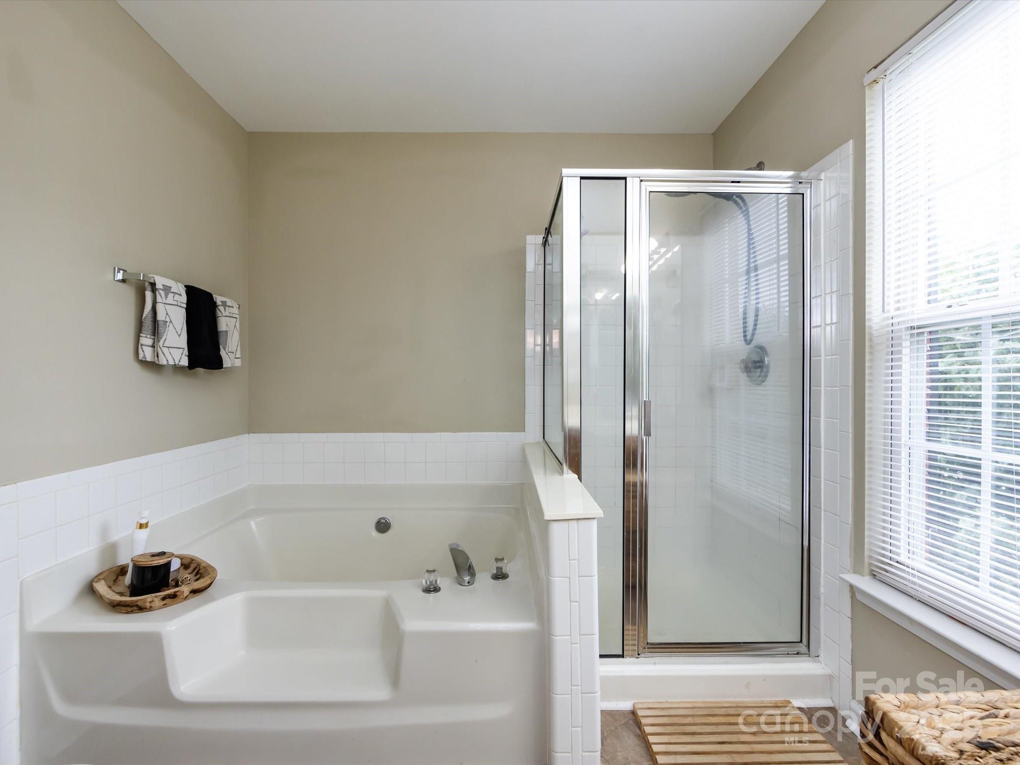 3910 Faith Church Road Indian Trail, NC 28079 - Photo 30 of 47 a bathroom with a bathtub and a shower