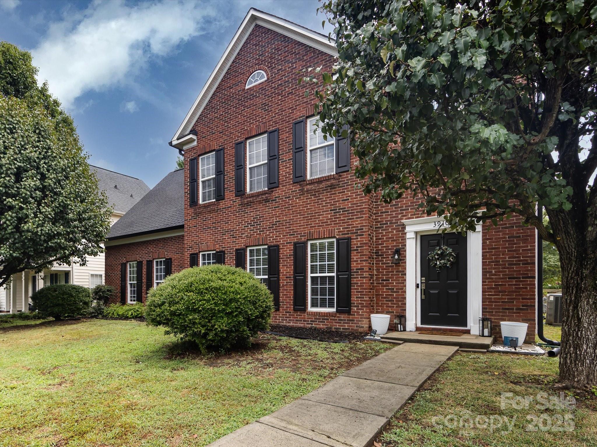 3910 Faith Church Road Indian Trail, NC 28079 - Photo 3 of 47 a view of a brick house with a large windows and a large tree