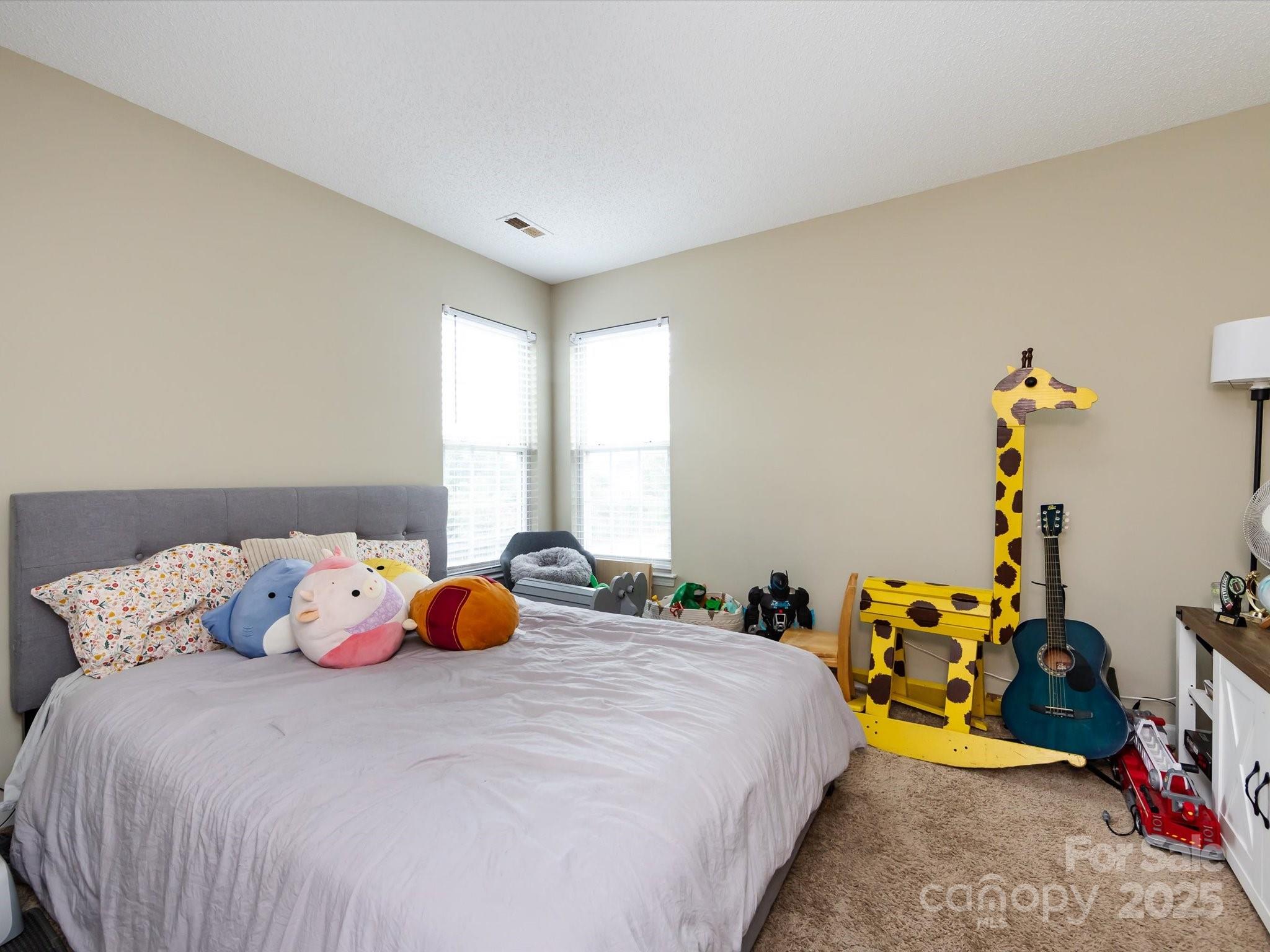 3910 Faith Church Road Indian Trail, NC 28079 - Photo 33 of 47 a bedroom with a bed and a couch