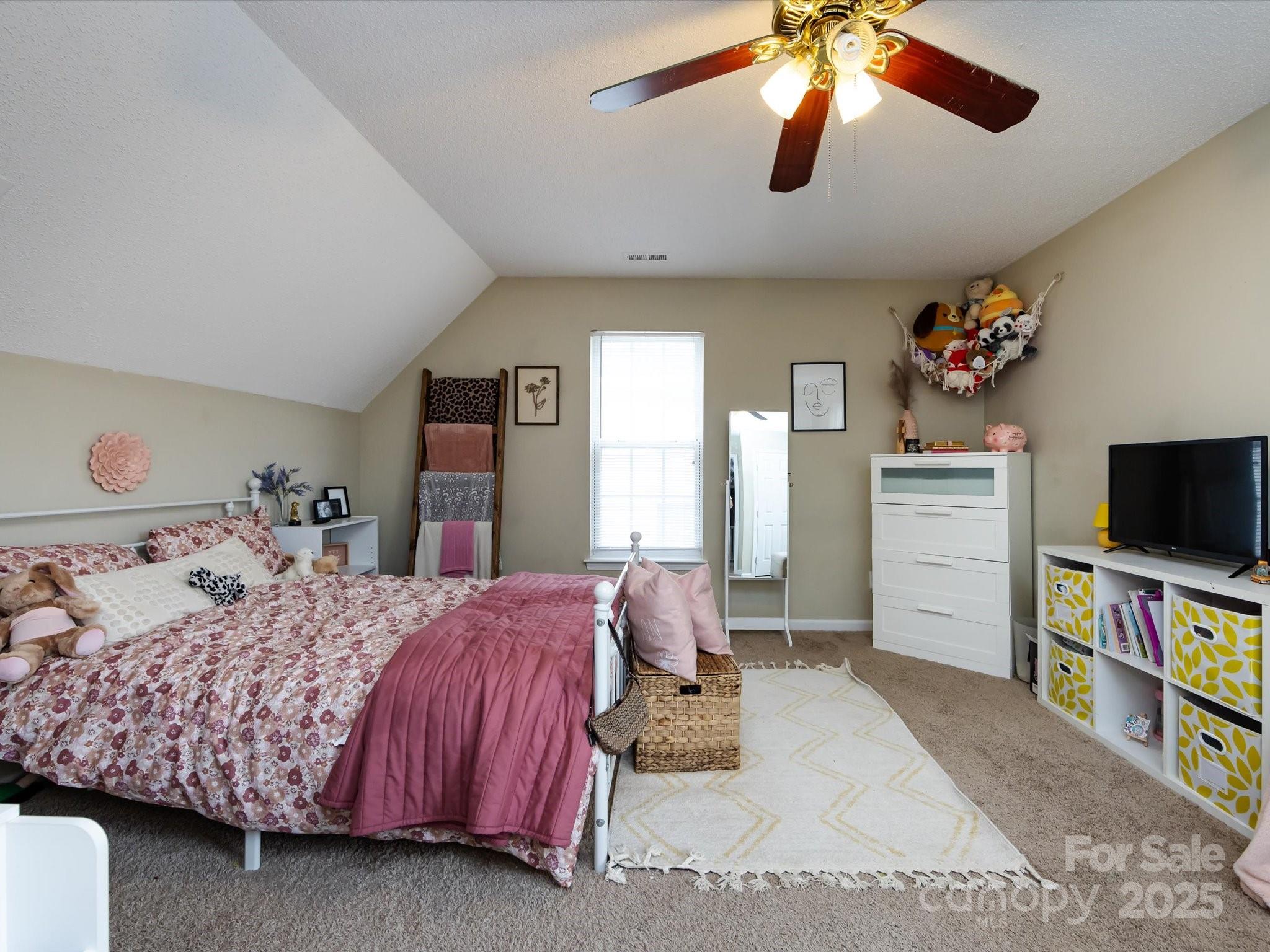 3910 Faith Church Road Indian Trail, NC 28079 - Photo 37 of 47 a bedroom with a bed and a flat screen tv
