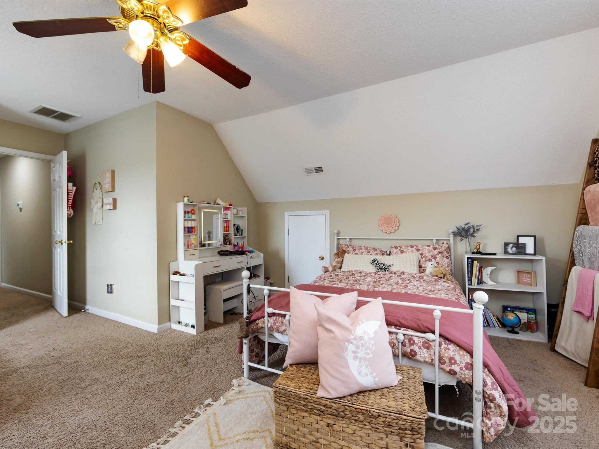 3910 Faith Church Road Indian Trail, NC 28079 - Photo 38 of 47 a bed room with a bed and a chandelier