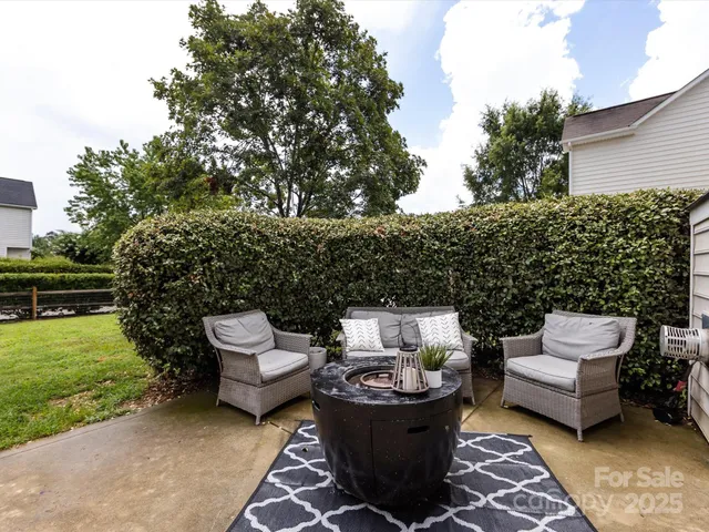 a view of a backyard with sitting area