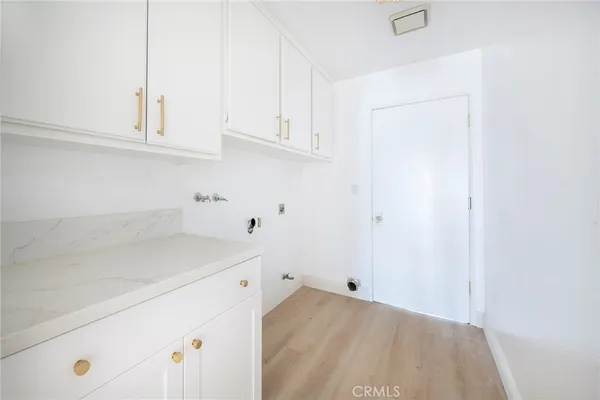 a view of storage and utility room with window