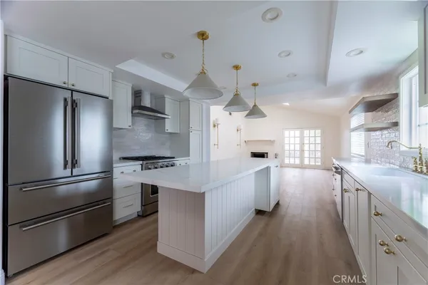 a kitchen with cabinets and stainless steel appliances