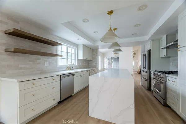 a kitchen with granite countertop a stove and refrigerator