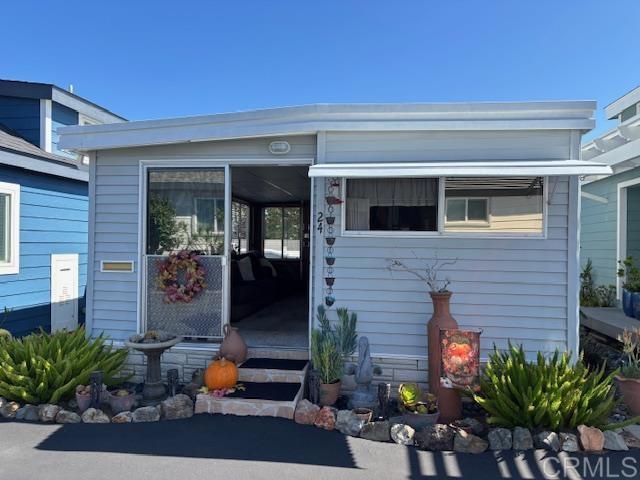 a front view of a house with sitting area