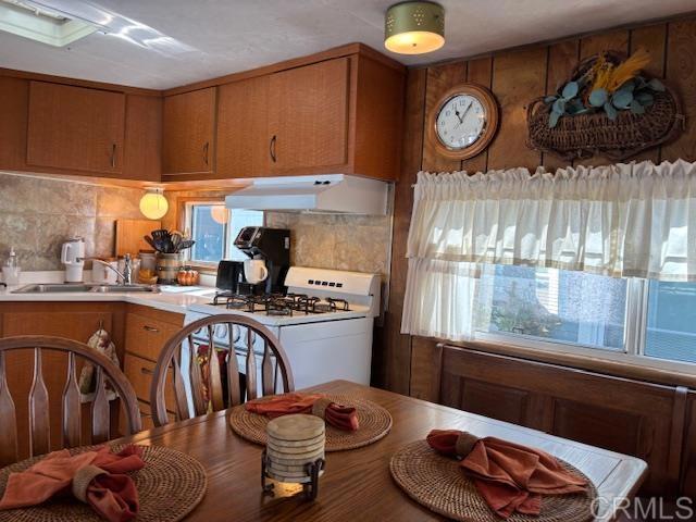 170 Diana Street, Unit 24 Encinitas, CA 92024 - Photo 14 of 26 a kitchen with stainless steel appliances granite countertop a stove a sink and a microwave