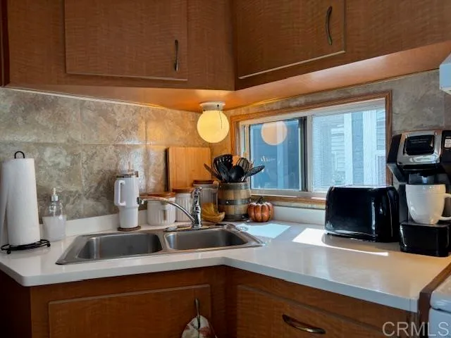 a kitchen with a sink and a refrigerator