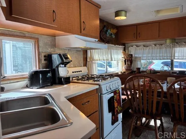 a kitchen with a stove a sink and a refrigerator