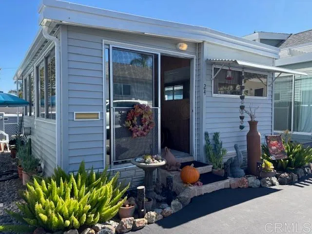 a front view of a house with sitting area