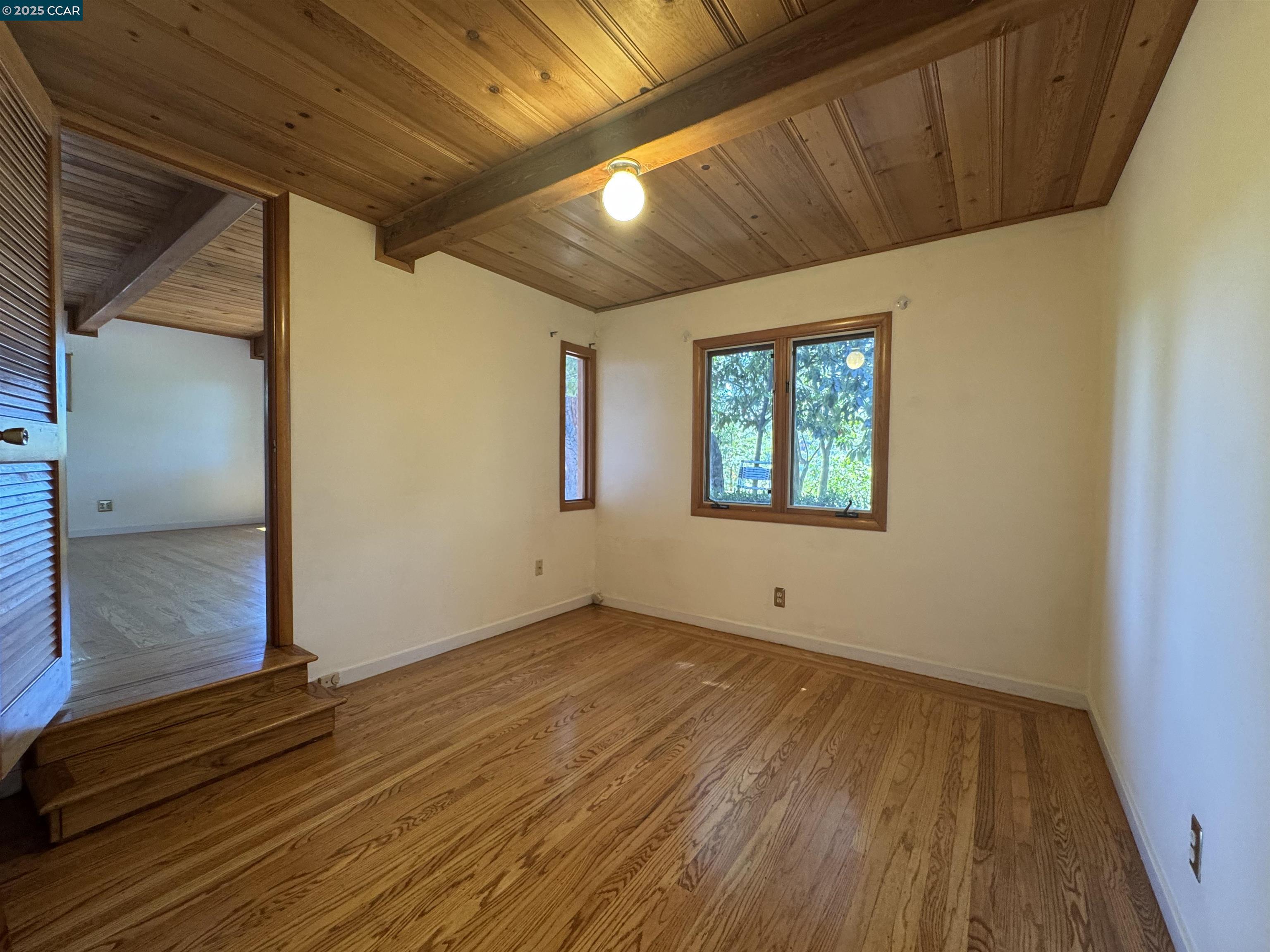 919 Janet Lane Lafayette, CA 94549 - Photo 16 of 29 a view of an empty room with wooden floor and a window
