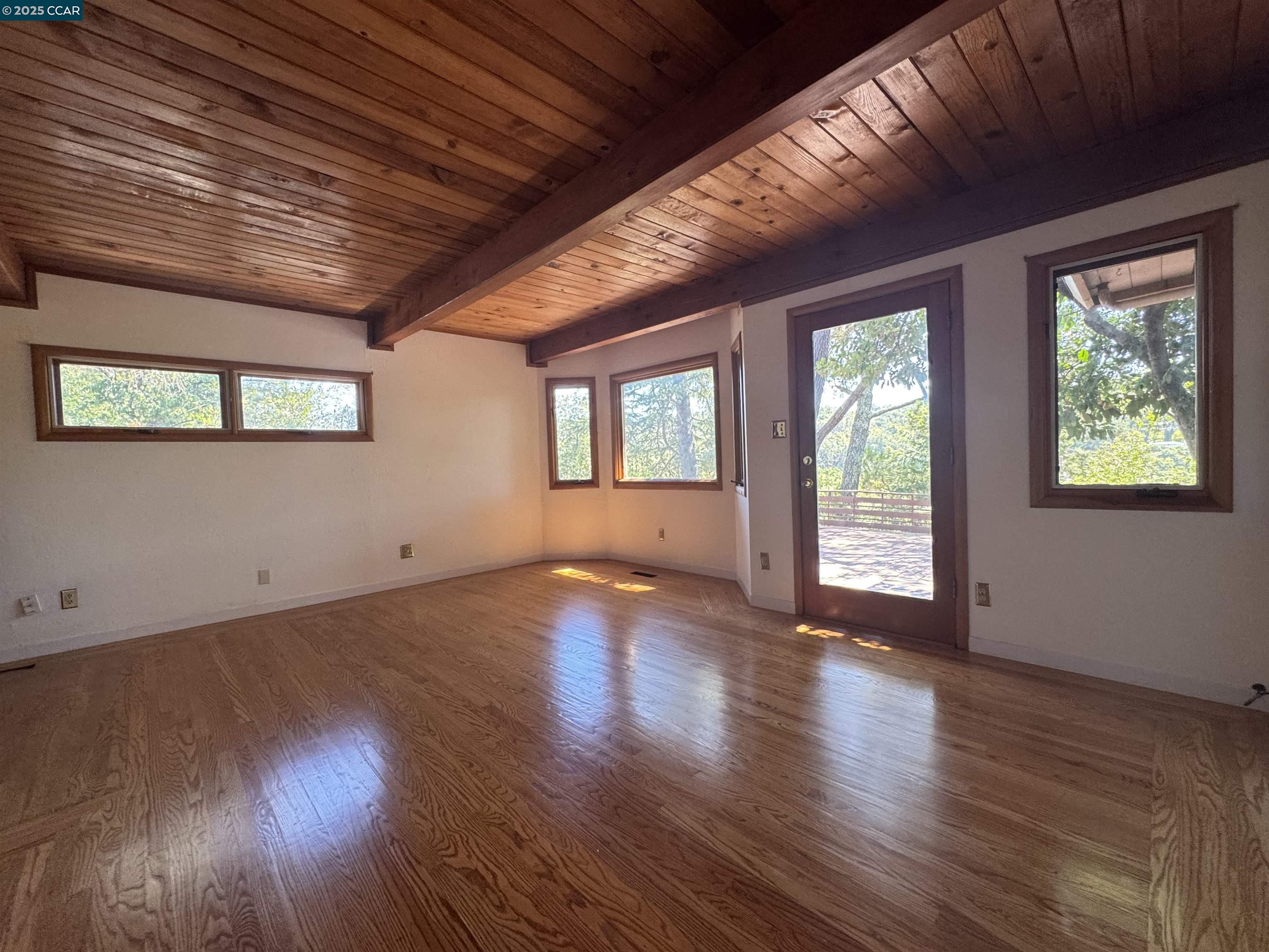 919 Janet Lane Lafayette, CA 94549 - Photo 18 of 29 a view of an empty room with wooden floor and a window