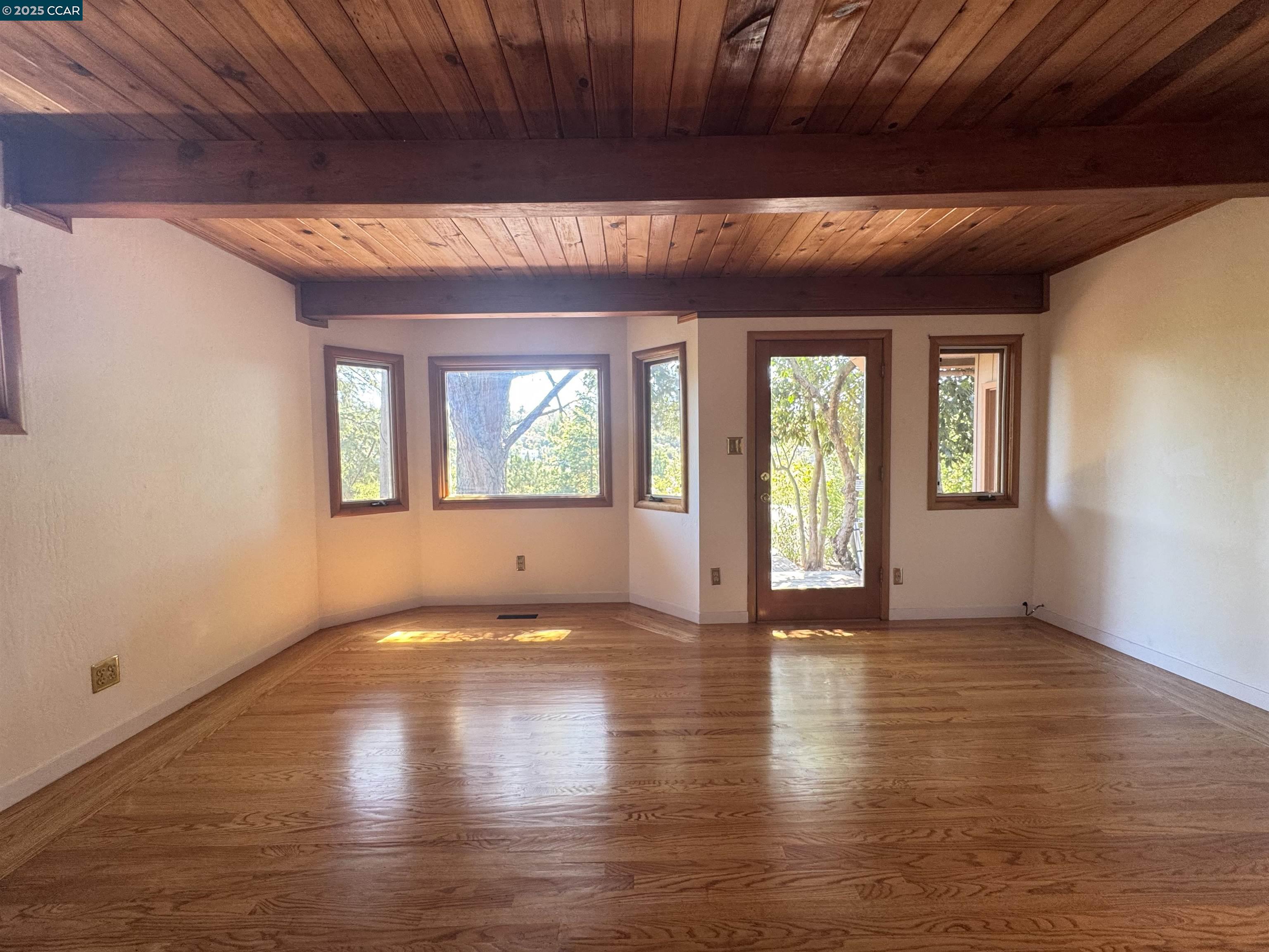 919 Janet Lane Lafayette, CA 94549 - Photo 20 of 29 a view of an empty room with wooden floor and a window