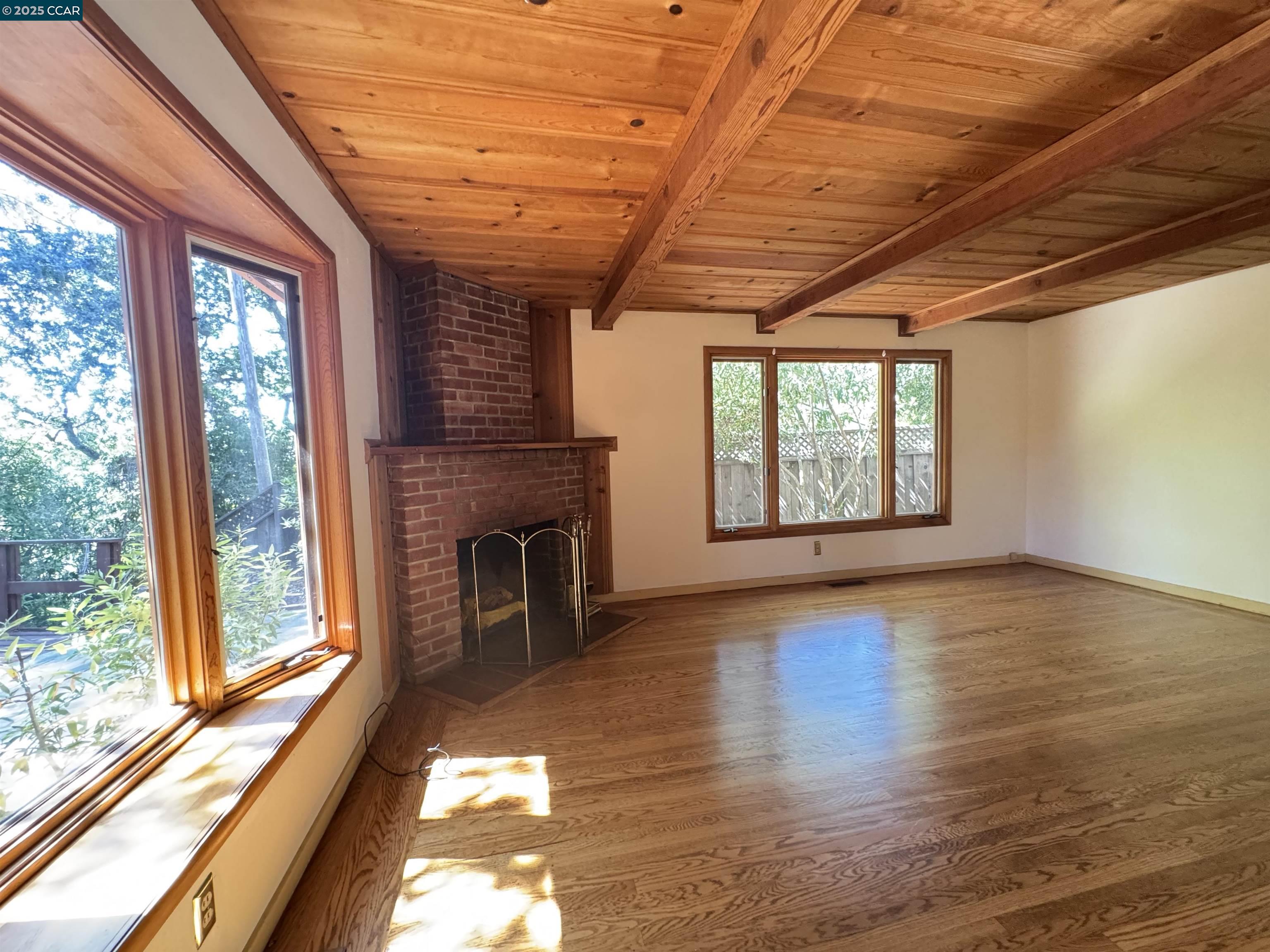919 Janet Lane Lafayette, CA 94549 - Photo 6 of 29 a view of an empty room with a window and wooden floor