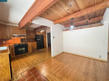 a view of a kitchen with a sink and cabinets