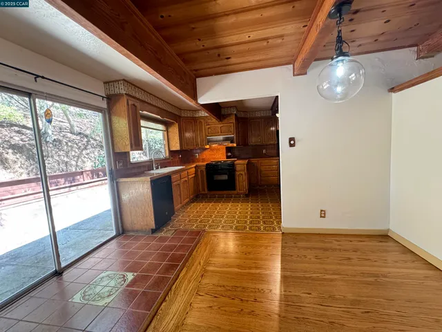 a view of a kitchen with a sink and wooden floor