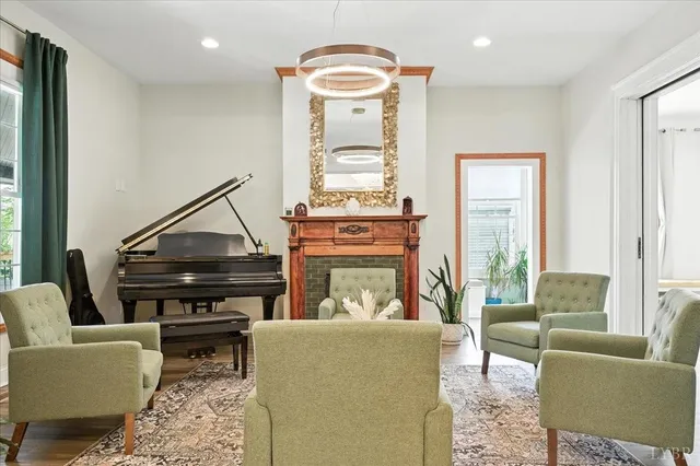 a living room with furniture and a large window with wooden floor