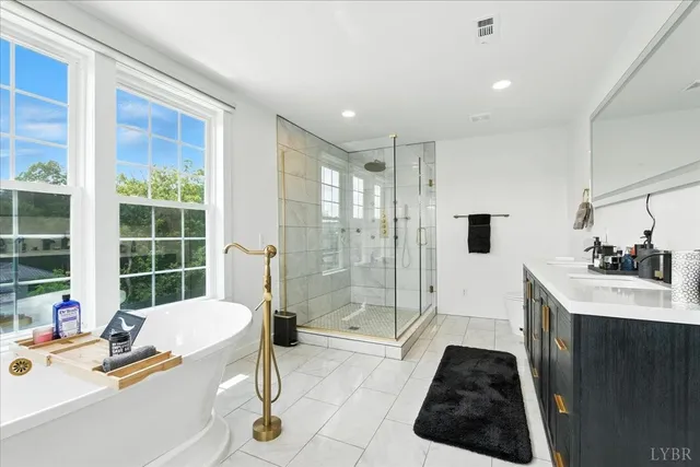 a large bedroom with a bed and a dresser