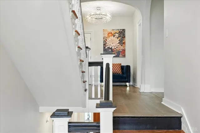 a spacious bedroom with a bed and a chandelier