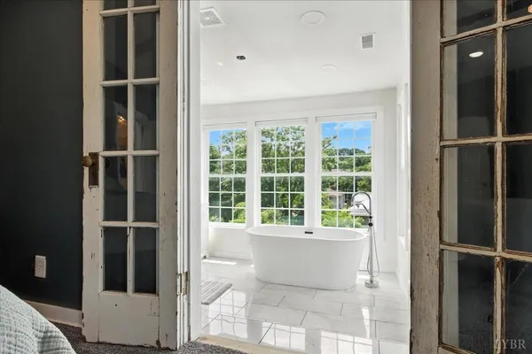 a view of entryway and hall with wooden floor