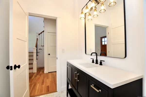 a bathroom with a double vanity sink a mirror and shower