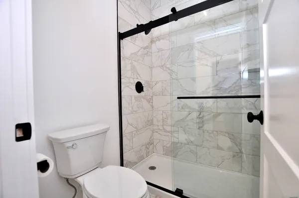 a bathroom with a toilet and shower