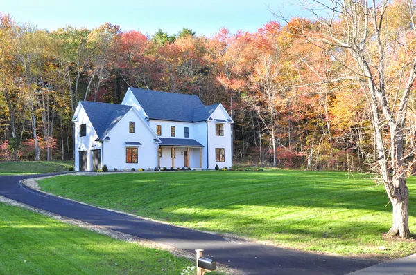 a front view of a house with a garden