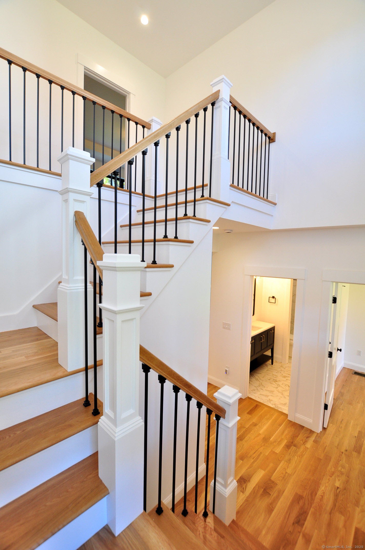 152 East Hill Road Canton, CT 06019 - Photo 2 of 36 a view of staircase with lots of frames on wall and wooden floor