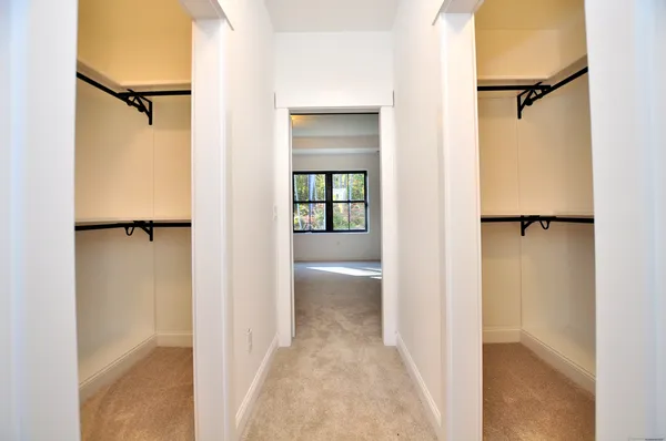 a view of a walk in closet and bathroom