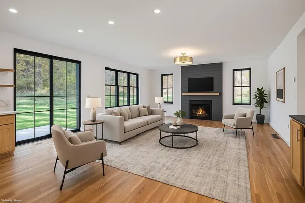 a living room with furniture a fireplace and a flat screen tv
