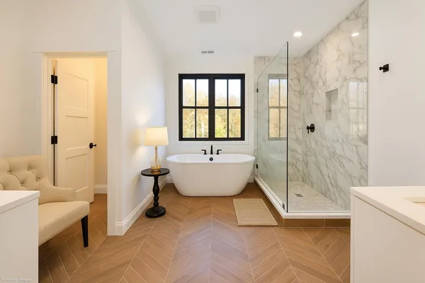 a bathroom with a bathtub and shower
