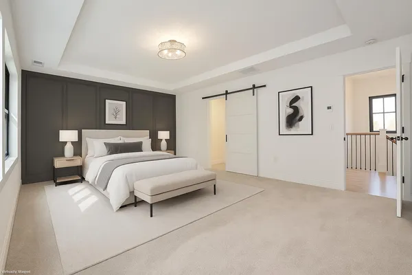 a bedroom with a bed and a night stand