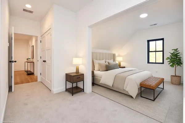 a spacious bedroom with a bed and a couch