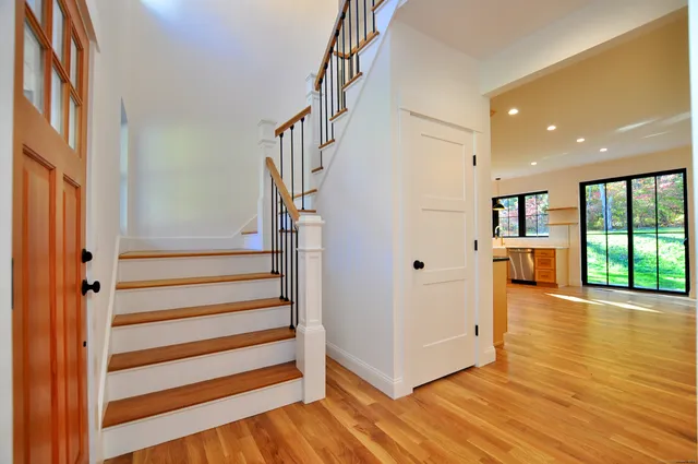 a view of entryway with wooden floor and stairs