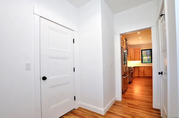a view of a hallway with wooden floor