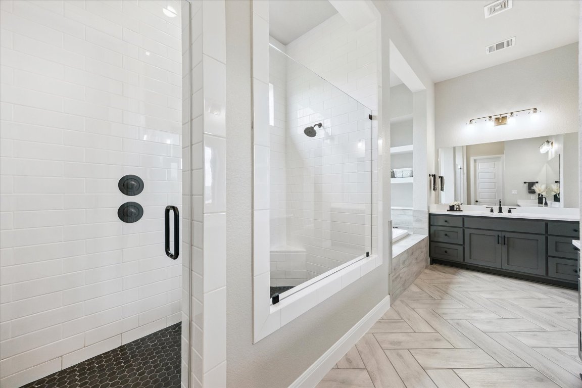 2113 Normandy View Leander, TX 78641 - Photo 12 of 23 a bathroom with a tub a sink and a mirror