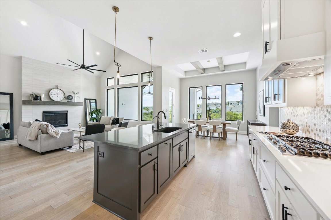 2113 Normandy View Leander, TX 78641 - Photo 7 of 23 a large room with kitchen view a stove a sink a dining table and chairs