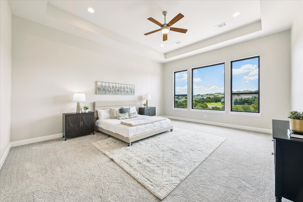 2113 Normandy View Leander, TX 78641 - Photo 10 of 23 a spacious bedroom with a large bed and a large window