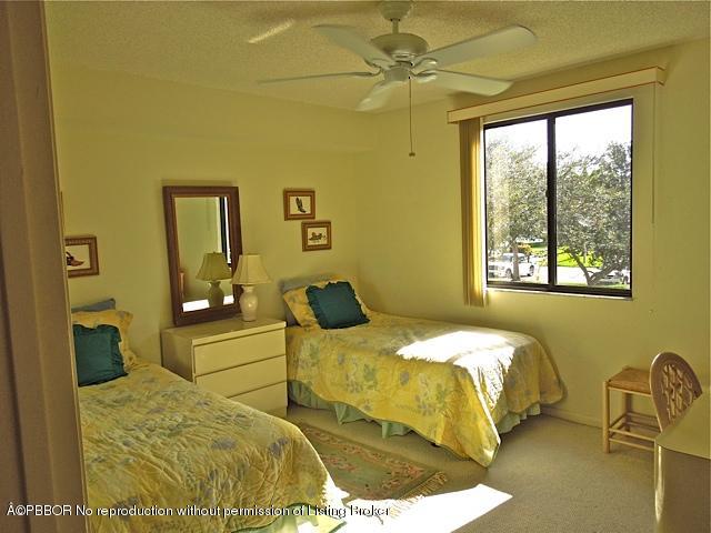 6157 Balboa Circle, Unit 206 Boca Raton, FL 33433 - Photo 15 of 31 a bedroom with a bed and a window