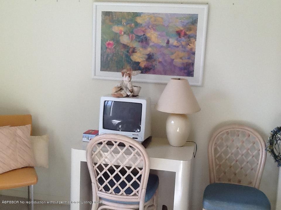6157 Balboa Circle, Unit 206 Boca Raton, FL 33433 - Photo 16 of 31 a bedroom with a bed and a lamp on the dresser