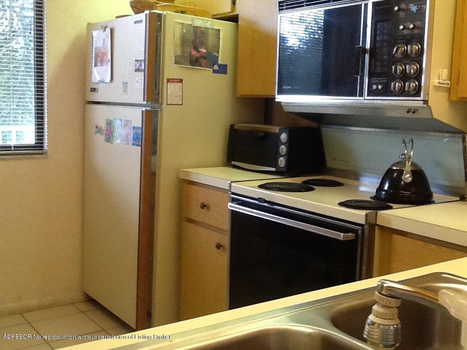 6157 Balboa Circle, Unit 206 Boca Raton, FL 33433 - Photo 19 of 31 a kitchen with a stove and a refrigerator