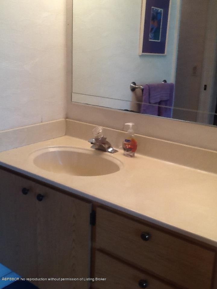 6157 Balboa Circle, Unit 206 Boca Raton, FL 33433 - Photo 21 of 31 a bathroom with a sink and a mirror