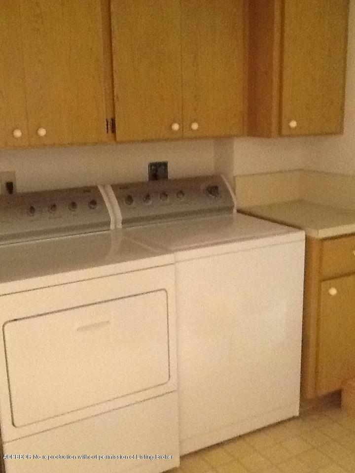 6157 Balboa Circle, Unit 206 Boca Raton, FL 33433 - Photo 25 of 31 a kitchen with a sink and a washer dryer