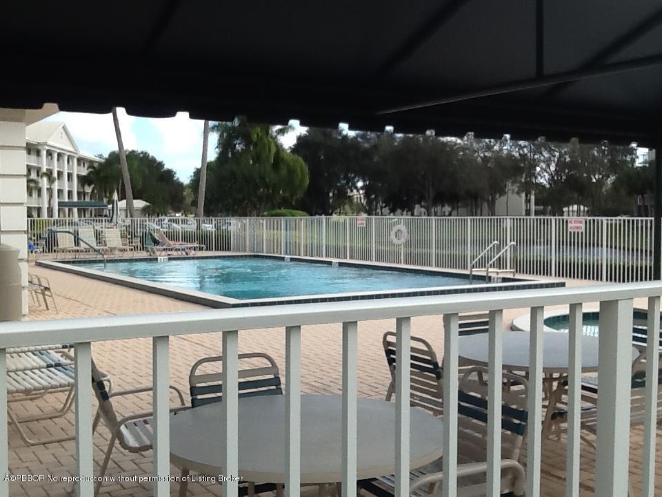 6157 Balboa Circle, Unit 206 Boca Raton, FL 33433 - Photo 26 of 31 a view of a patio with a table and chairs